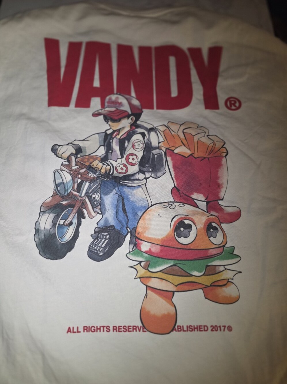 Vandy the Pink cream graphic T-shirt, size Medium, featuring a scooter rider, bu